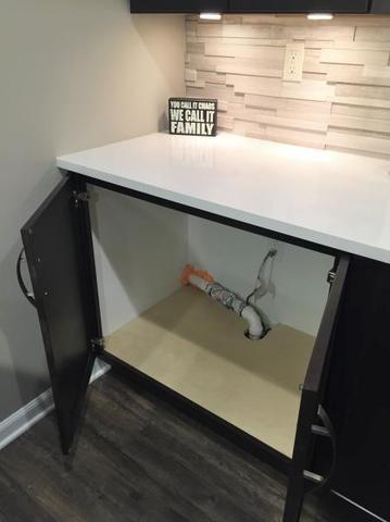 Sump pump hidden in basement bar cabinet in a Shelby Township, MI home