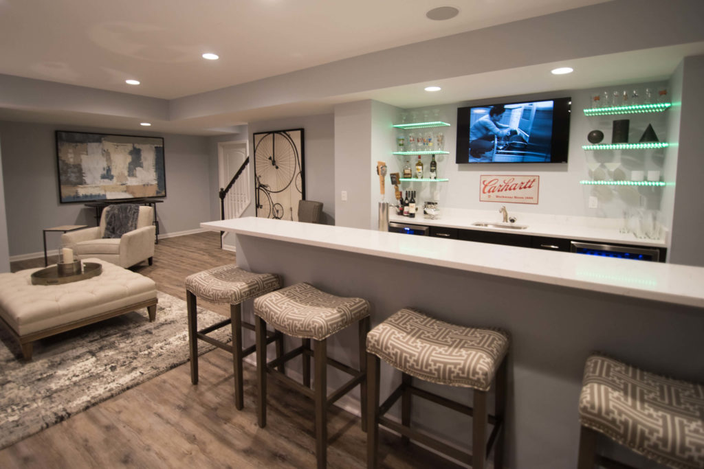 basement modern bar in Novi, MI with led glass shelving and brown rustic vinyl plank flooring