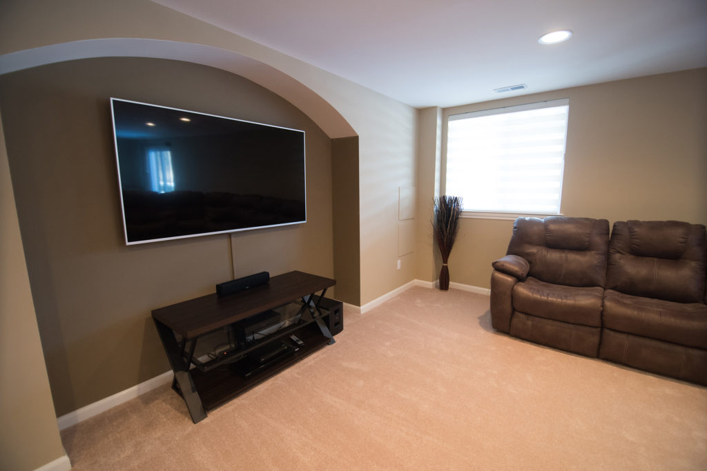 archway in wall of basement for TV
