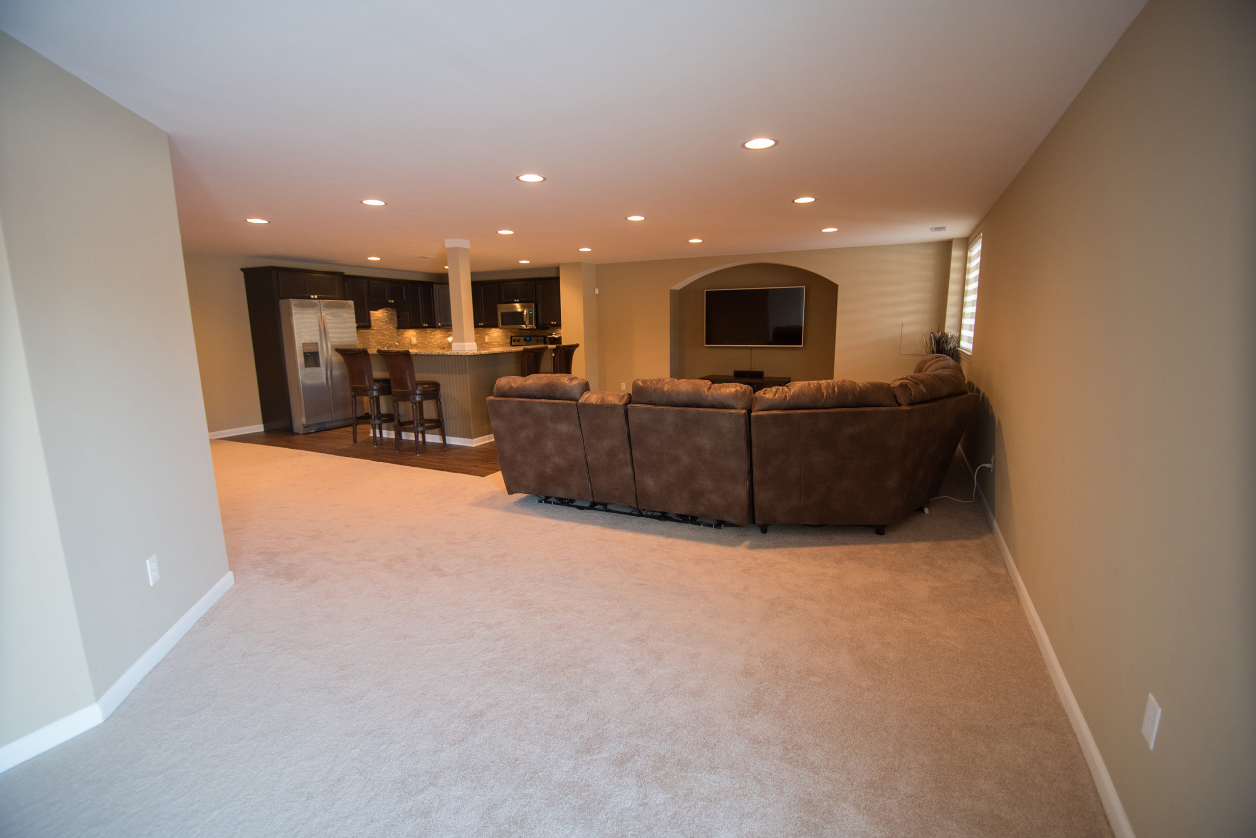 finished basement with living room and bar area