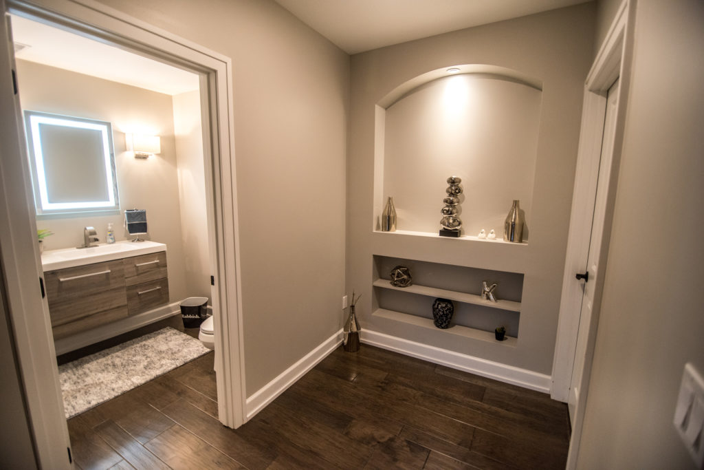shelving niche in hallway to basement bathroom
