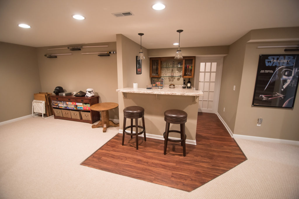 finished basement with bar area with vinyl plank flooring