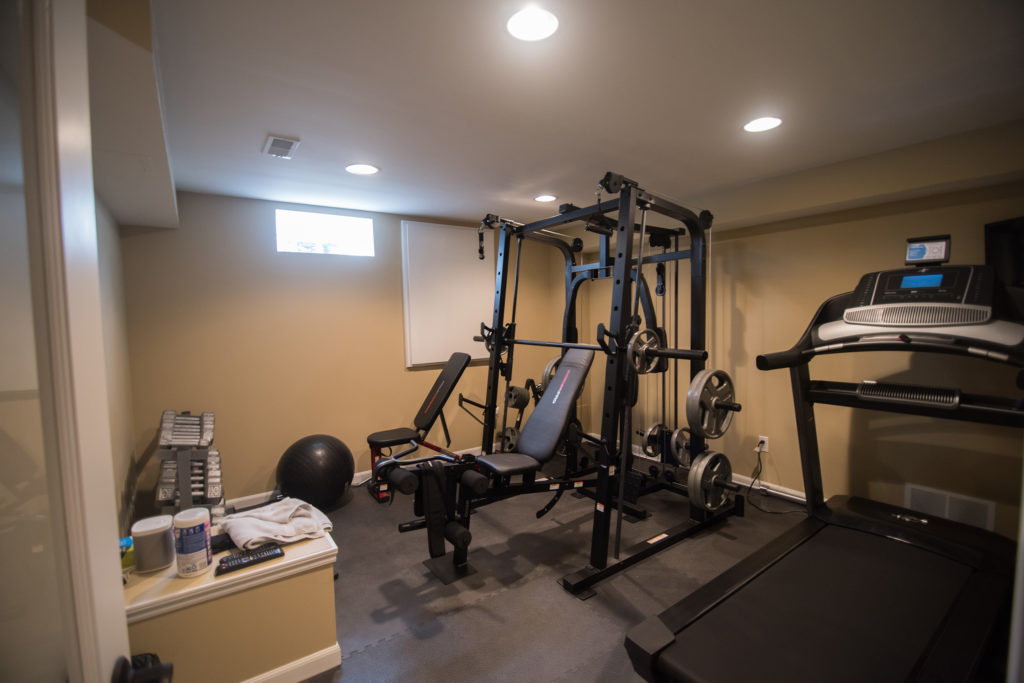 basement fitness room with rubber flooring