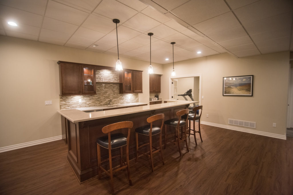 bar height seating behind island in basement bar