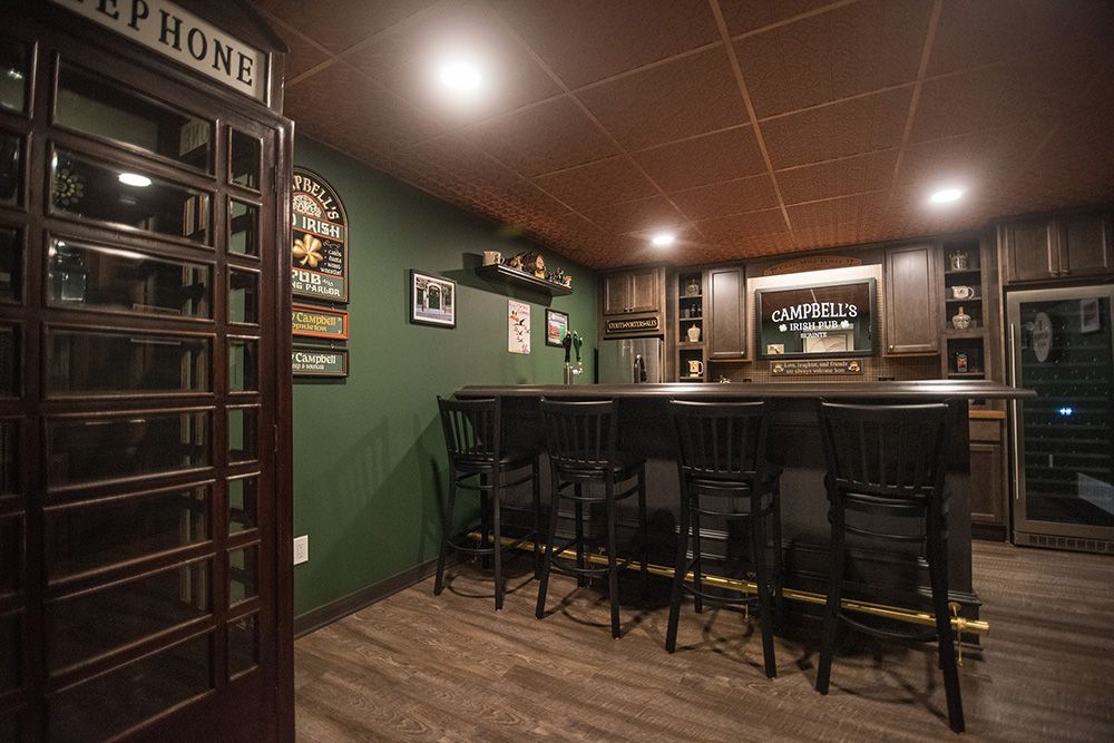 phone booth in finished basement with a pub style bar design