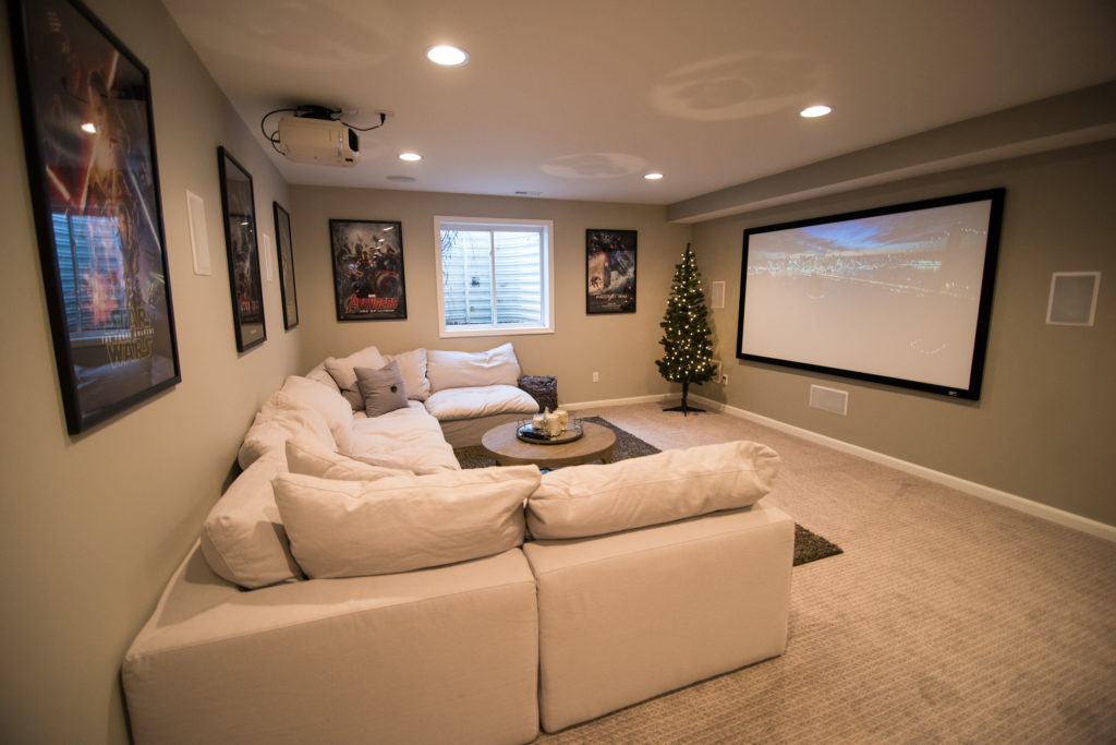 bright light grey basement with carpet and large sectional
