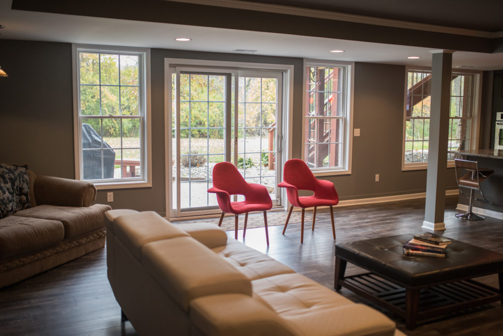 walkout basement with sectional seating area for entertaining