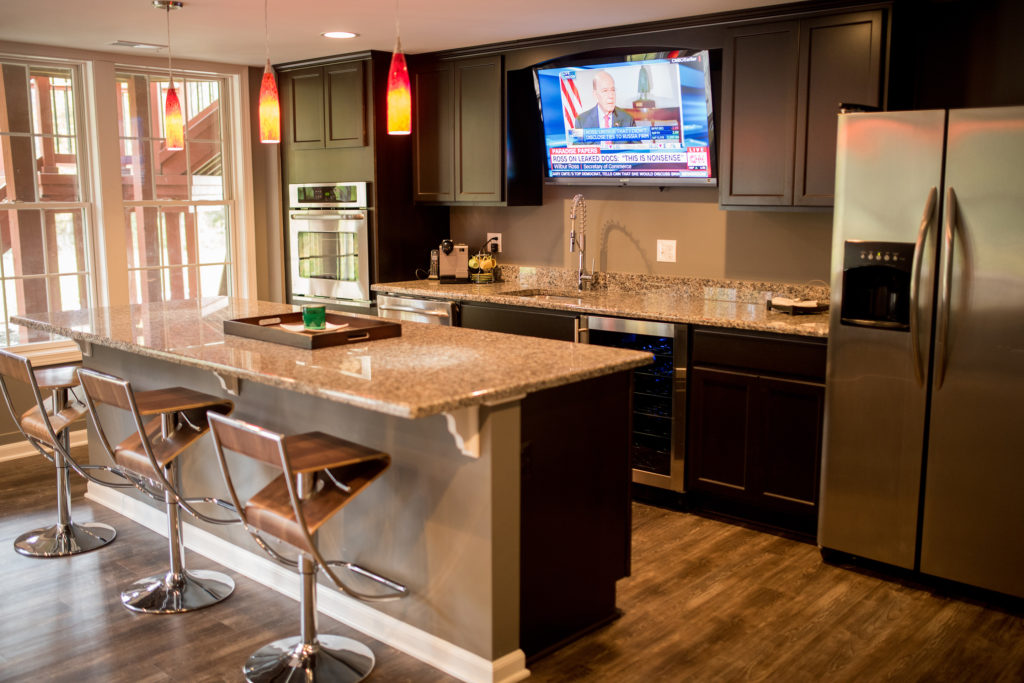 finished basement with kitchen space and large island with seating