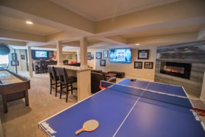 open concept basement with detailed ceiling and carpeting