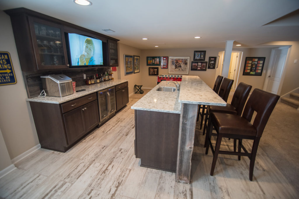 basement bar with vinyl tile and rustic reclaimed wood bar
