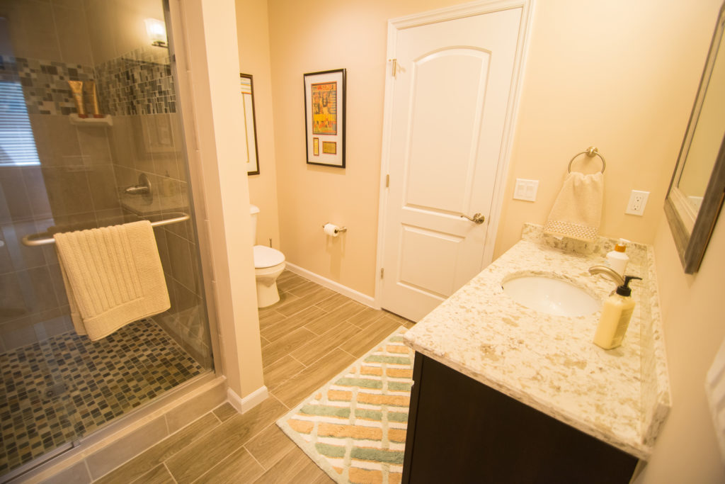 full bathroom in basement with vinyl tile and shower