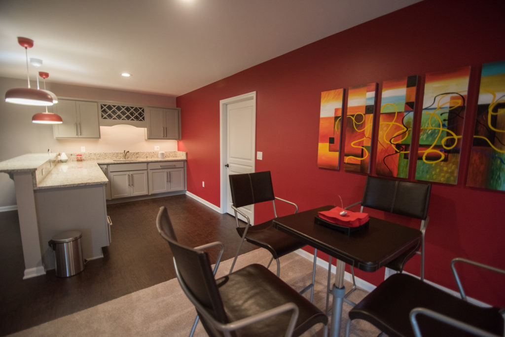 red accent wall in basement bar area
