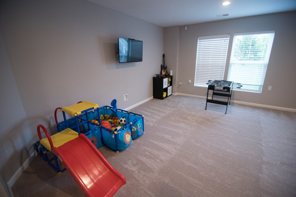 basement finishing carpet with TV area for the kids