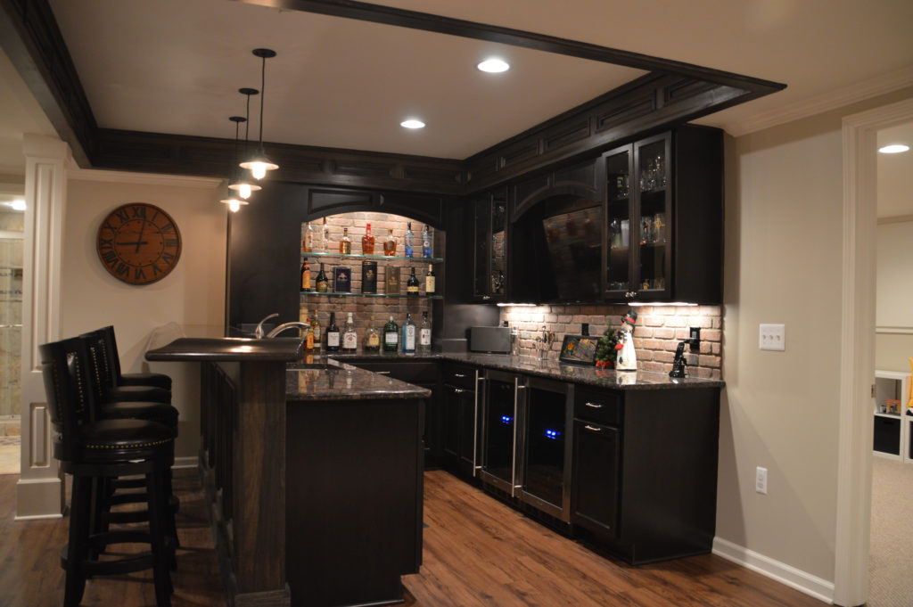 basement bar with tons of detail and dark cabintry