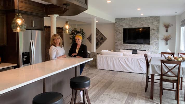 Two women in a finished basement kitchen