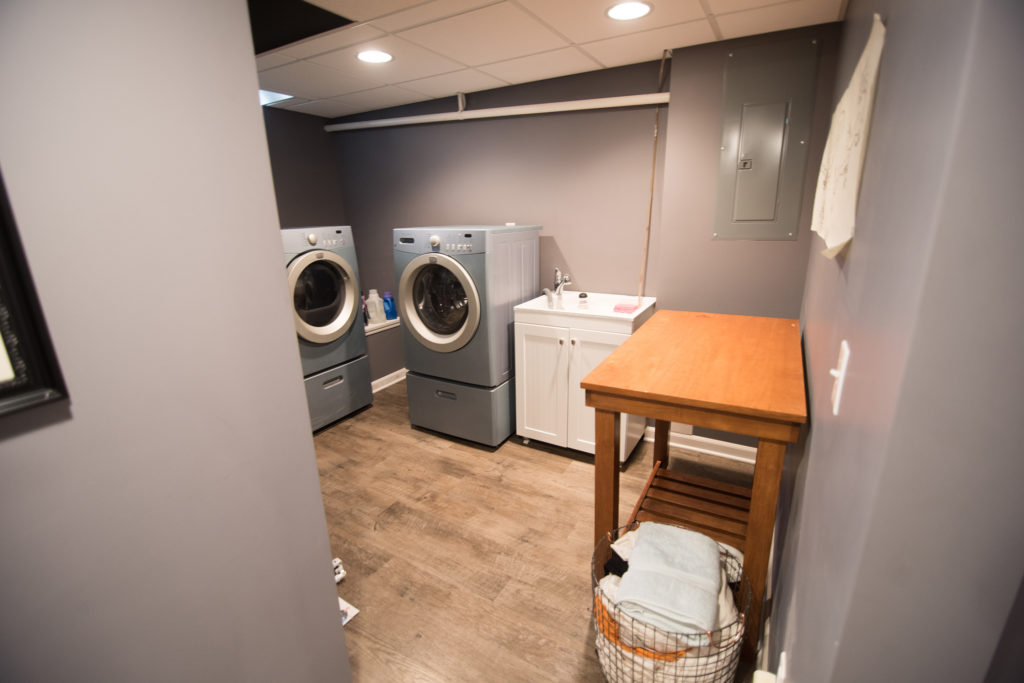 finished laundry room in basement with bright led lighting