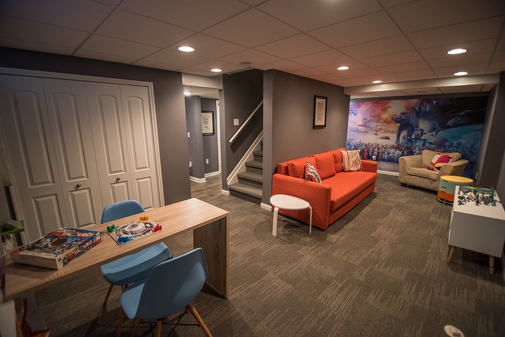 open concept finished basement designed for the kids to use with bright colors