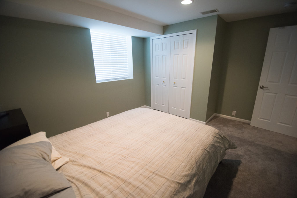 bedroom in basement with egress window and carpeting for comfort