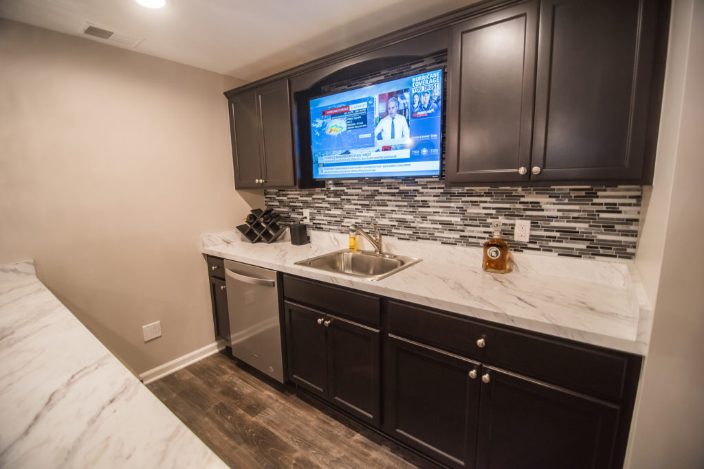 basement bar macomb with dark cabinets and laminate countertop