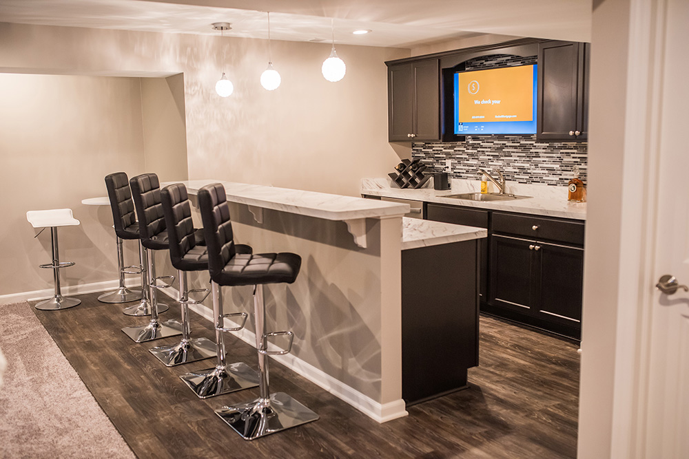 basement bar with dark cabinets and white countertop