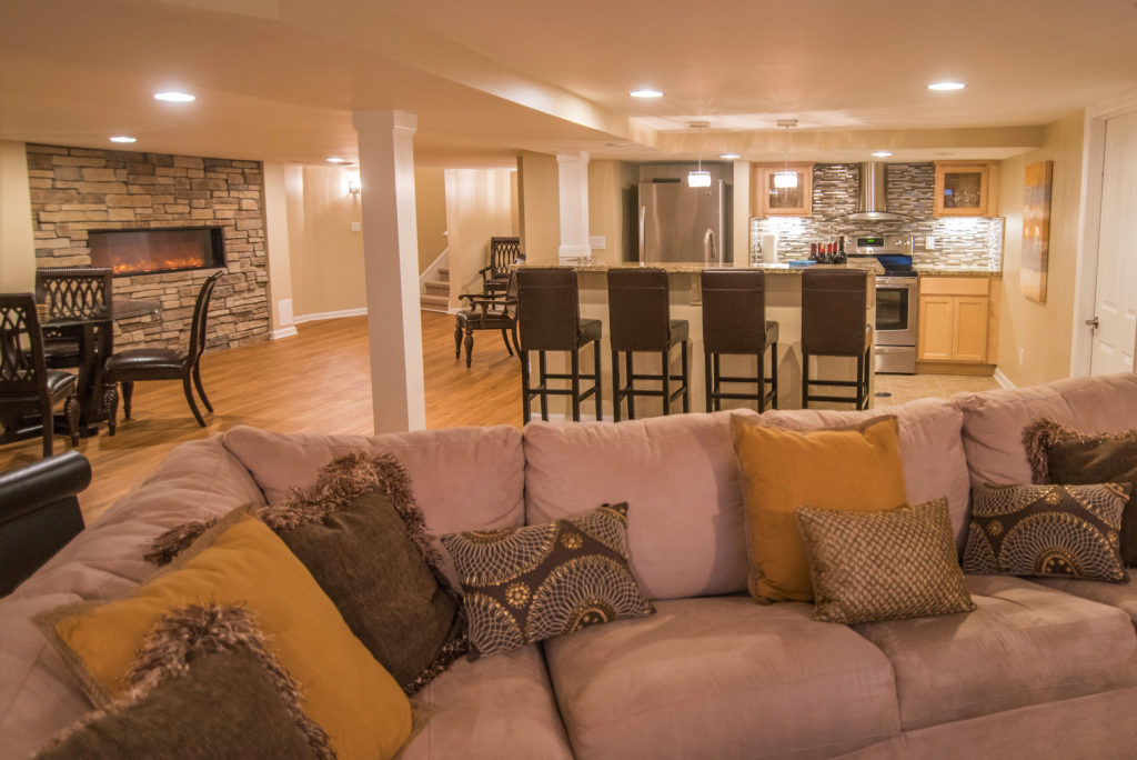 bright finished basement in northville with kitchen and fireplace