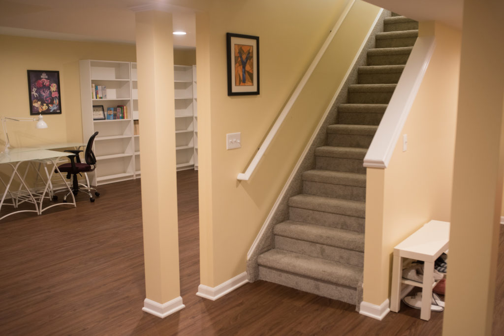 open view staircase into basement with study area behind