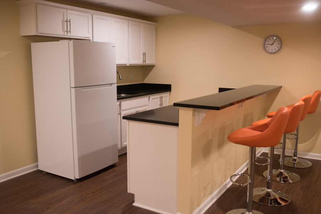 basement bar area with white cabinets