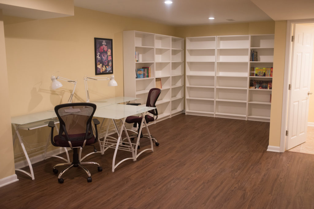 study area in basement for kids with desks and bookshelves