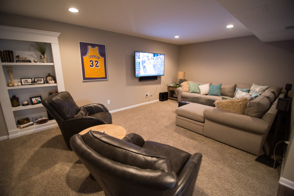 cozy basement living room with secret door and tv