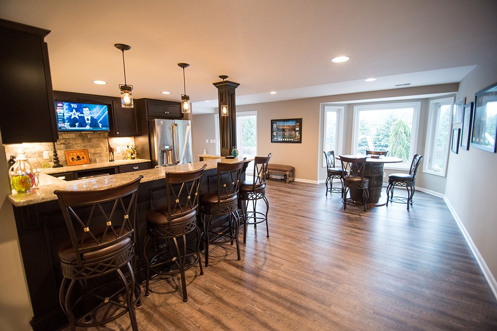 walkout basement with dark vinyl plank and custom bar