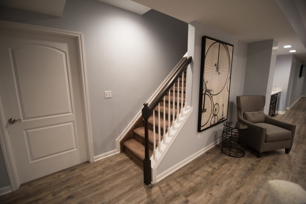 open view staircase with spindles entering basement for welcoming design