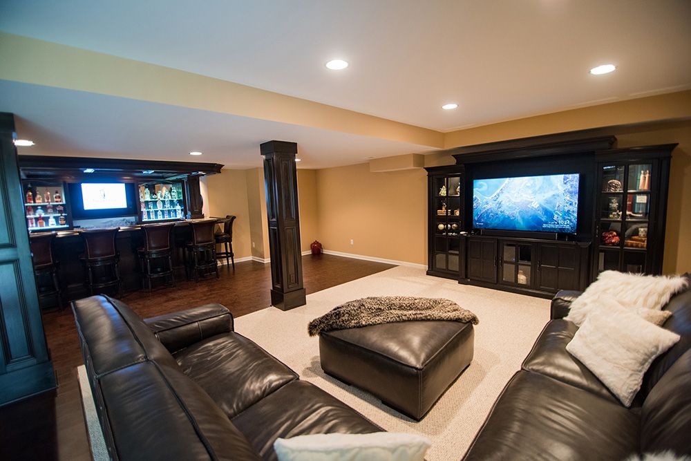 open concept living and dining in basement with large bar and media center
