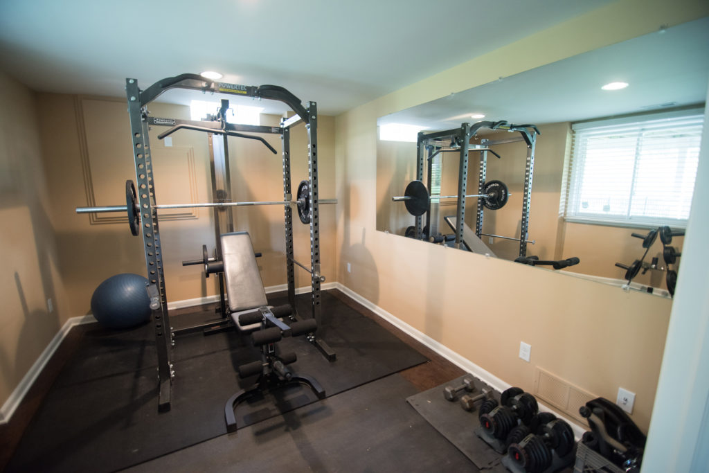 home fitness room in basement with french doors