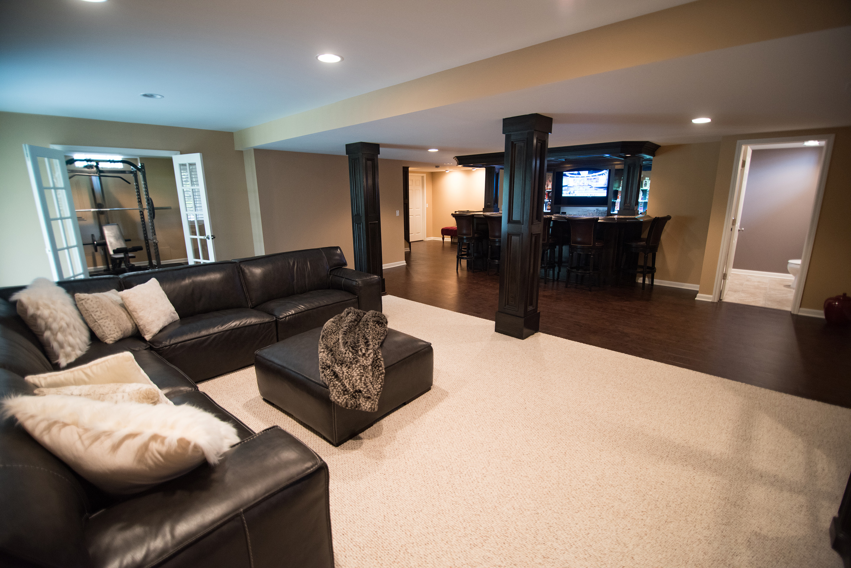 Novi Michigan finished basement with dark cabinets and living room
