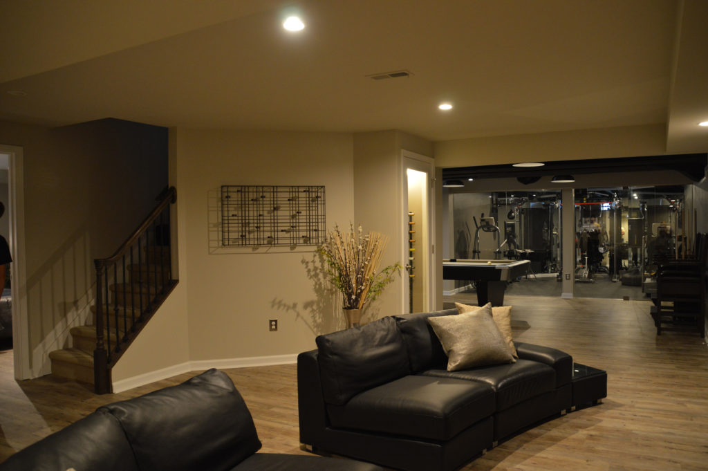 open concept basement living room with sofas