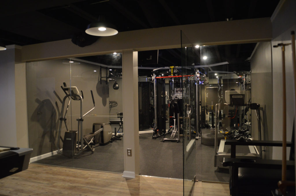 basement fitness room with glass walls for open views