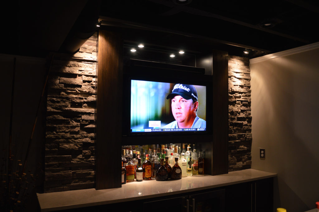 stone backing on bar with wall mounted tv