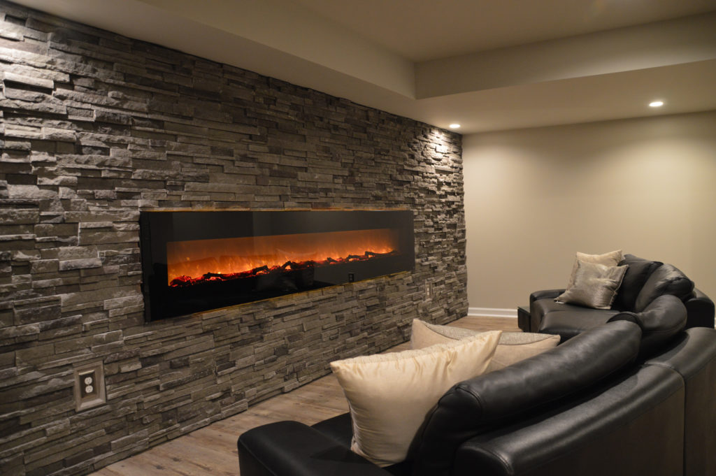 large fireplace on basement wall electric and stone