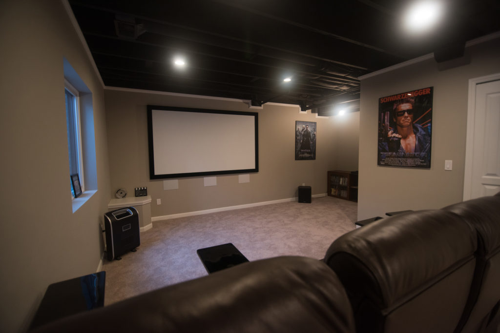 home movie theater with projector carpet and painted ceiling
