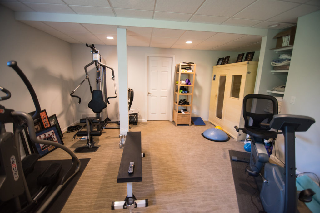 fitness room in basement with weight lifting equipment and a sauna