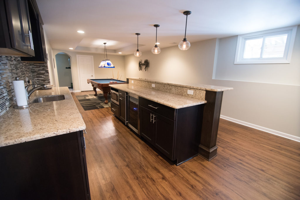 bar island in finished basement with granite countertops