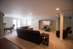 spacious cozy basement living room with carpet in lower level