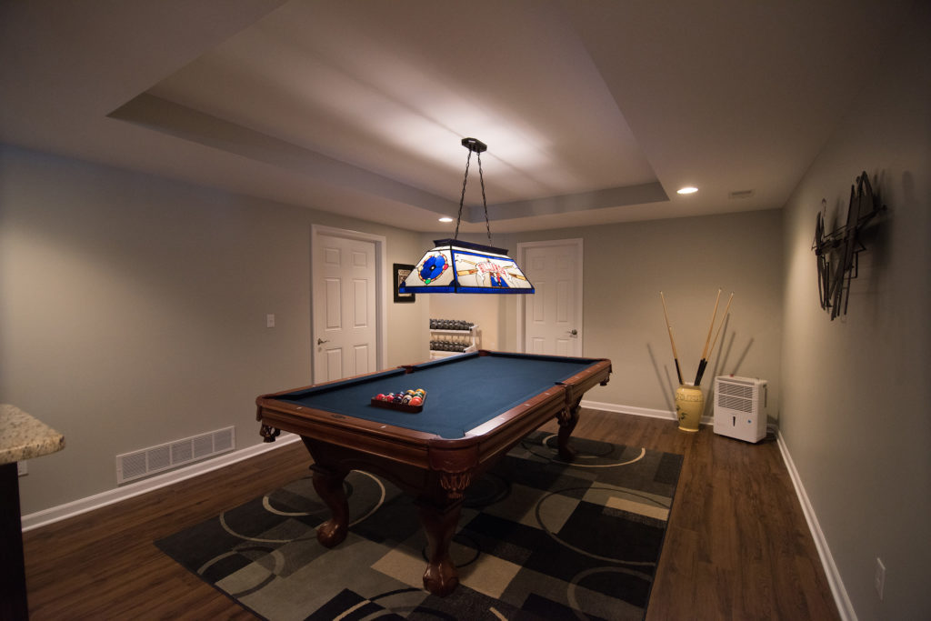 pool table with raised ceiling detail in finished basement