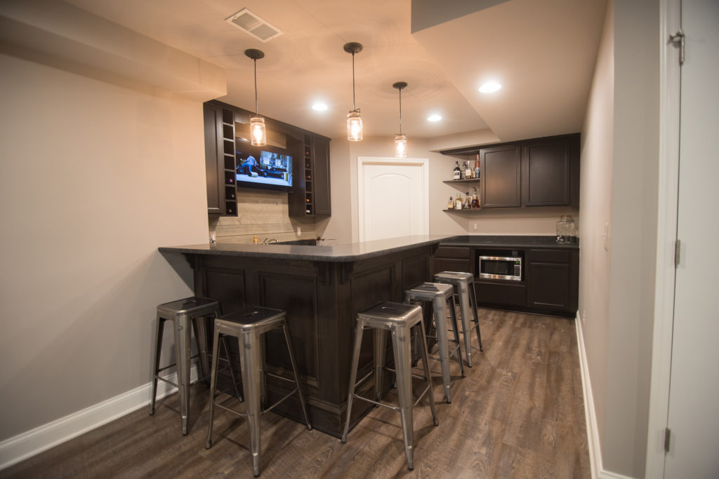 after image of basement with vinyl plank flooring and rustic design