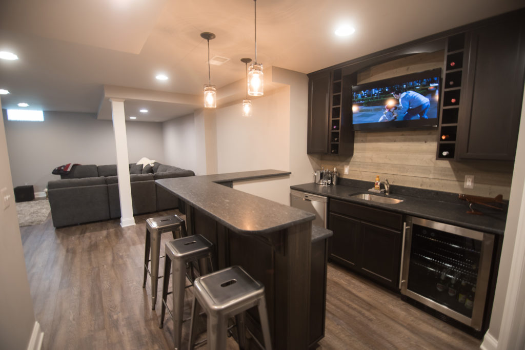 rustic bar in basement overlooking basement living room