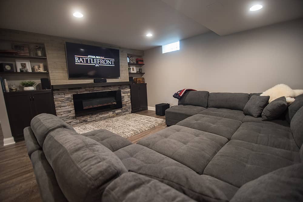 Wixom Michigan large sofa and tv wall with fireplace and stone