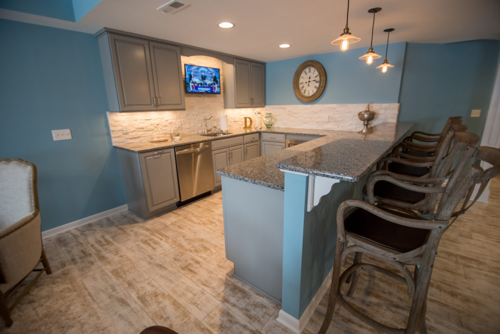 basement bar with granite countertops and extra seating