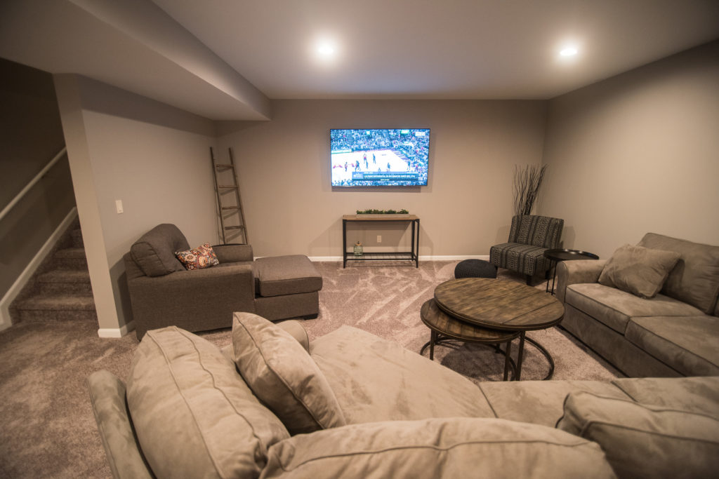 grey carpet with large couch and tv