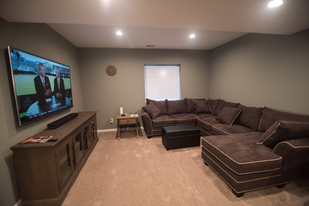 spacious basement living room with big screen tv