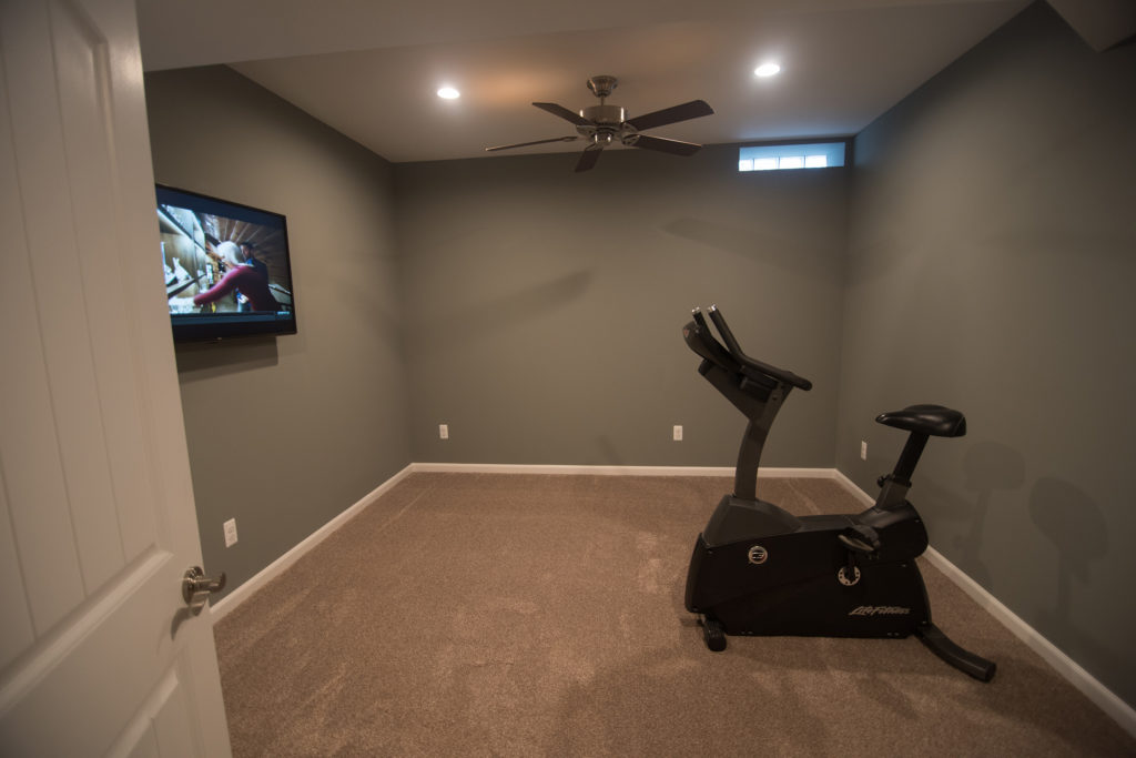 bonus room in basement being used as a fitness space